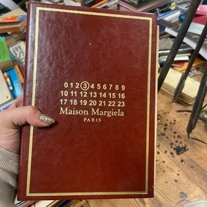 Maison Margiela Whispers in the Library Perfume in special packaging.